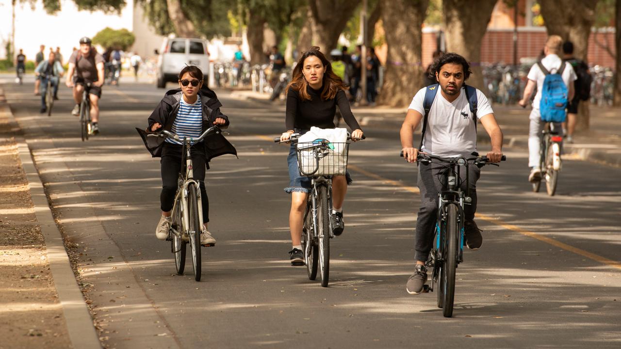 Students biking near the quad
